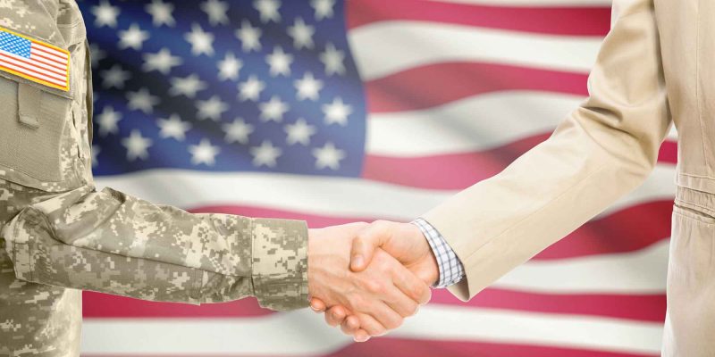 Veteran and business professional handshake representing SBA loan financing for veteran-owned businesses
